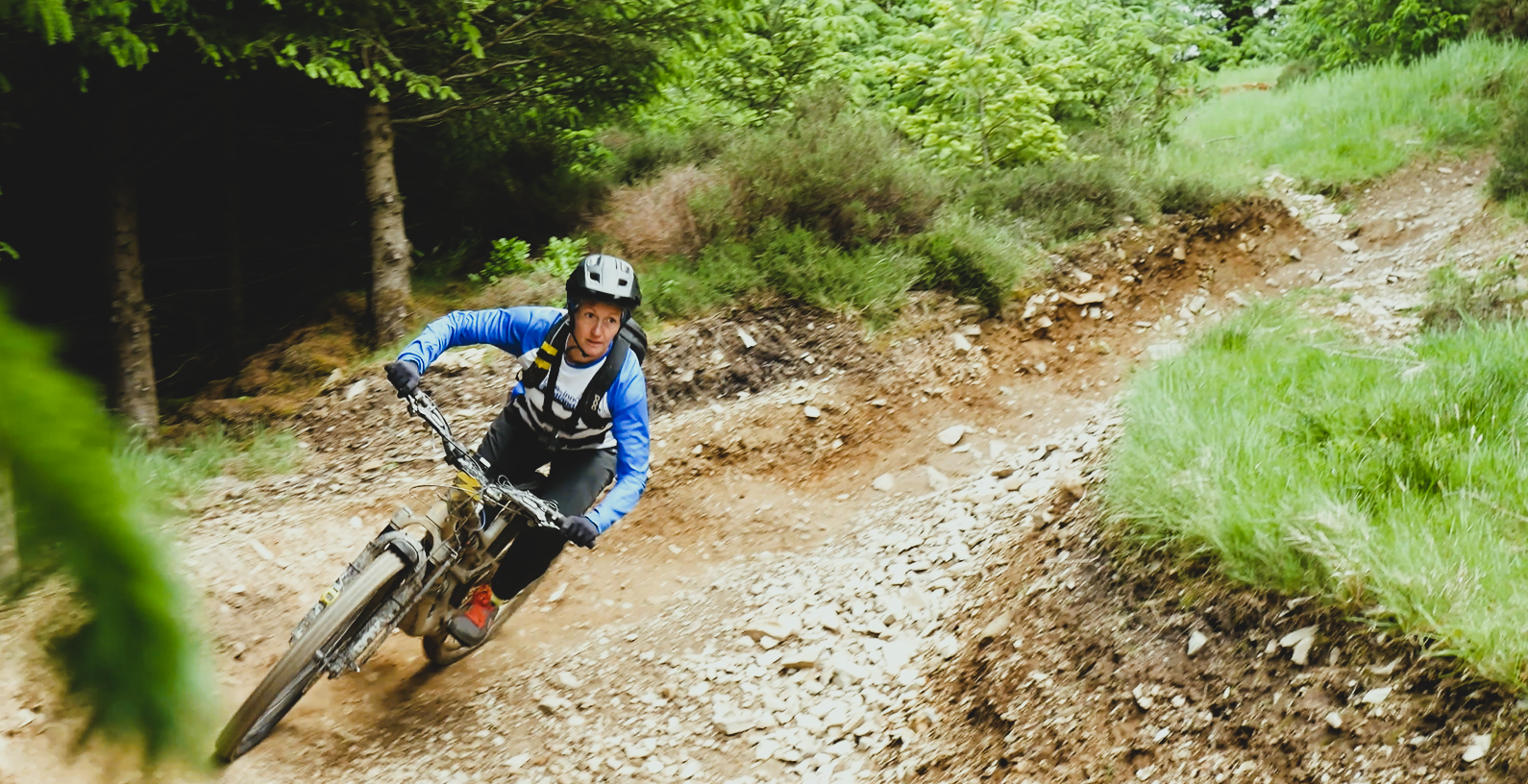 Person riding a bike in a green forest