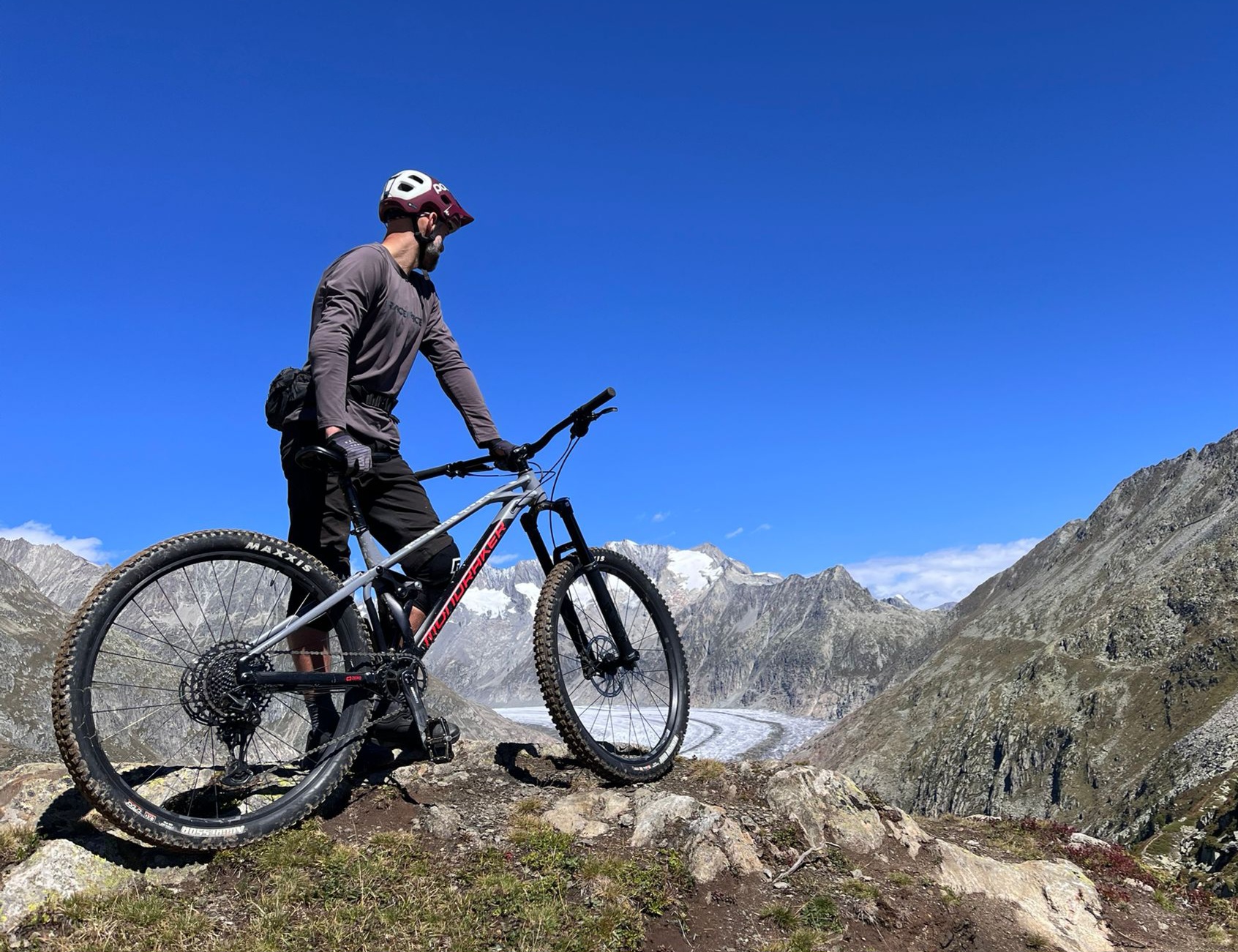 Professor Tom Campbell with his bike on a hill looking ahead